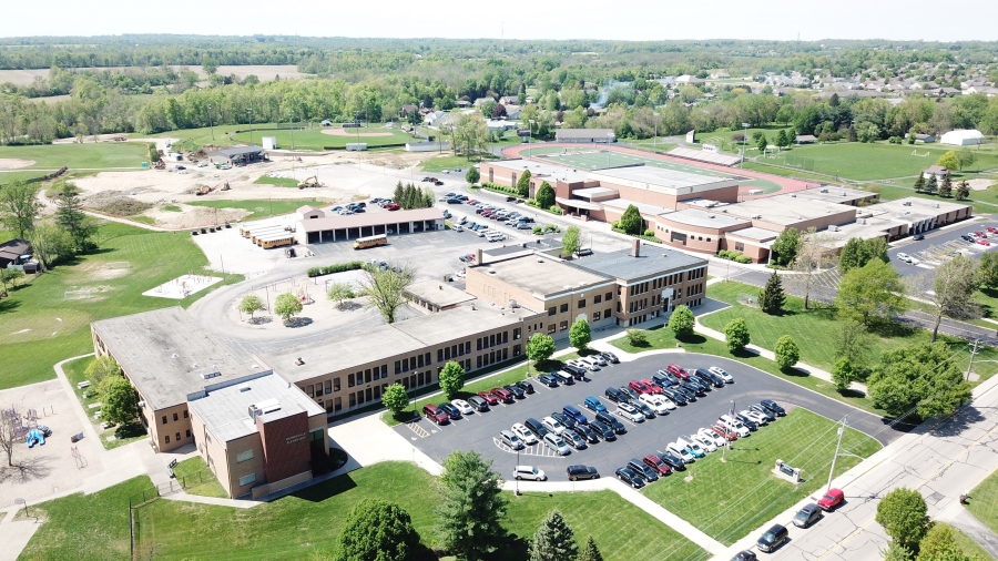 image of a building with car in the parking lot